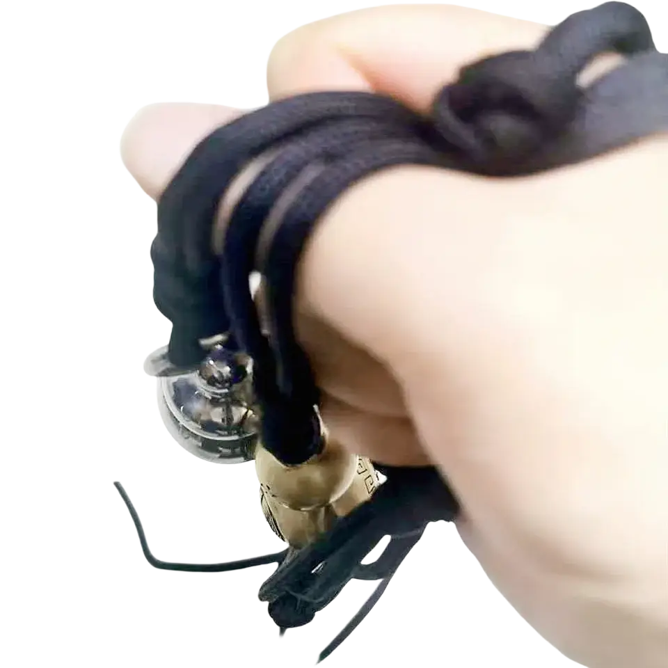 Black braided cord bracelet with silver-toned bell and brass-colored bead featured in brass gourd self defense pendant necklace