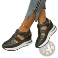 Black breathable hollow wedge platform sandals with multiple velcro strap closures and a white rubber sole