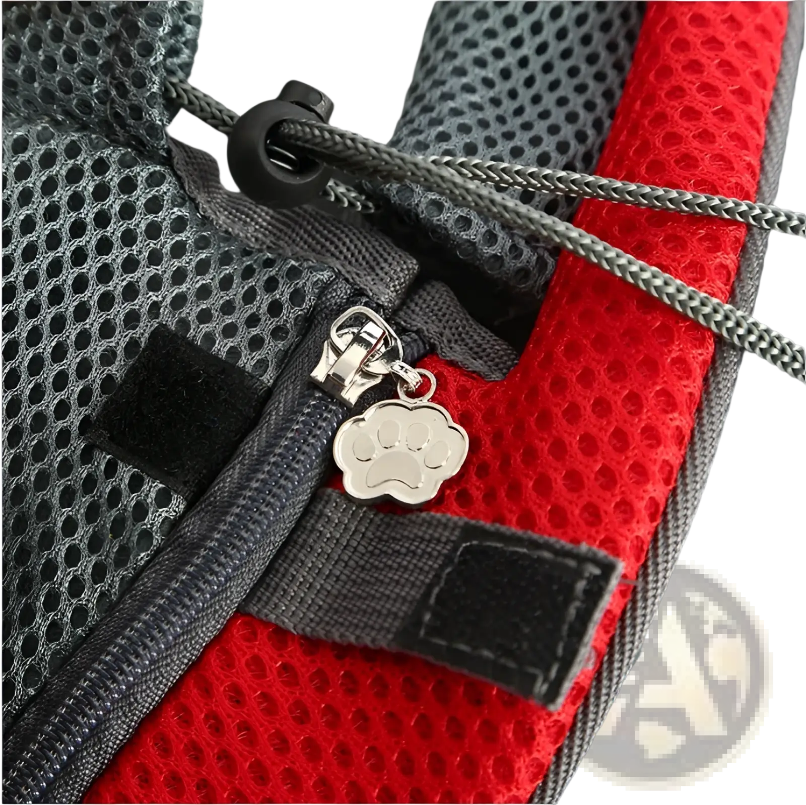 A silver paw print zipper pull on a red and gray breathable mesh pet carrier backpack harness