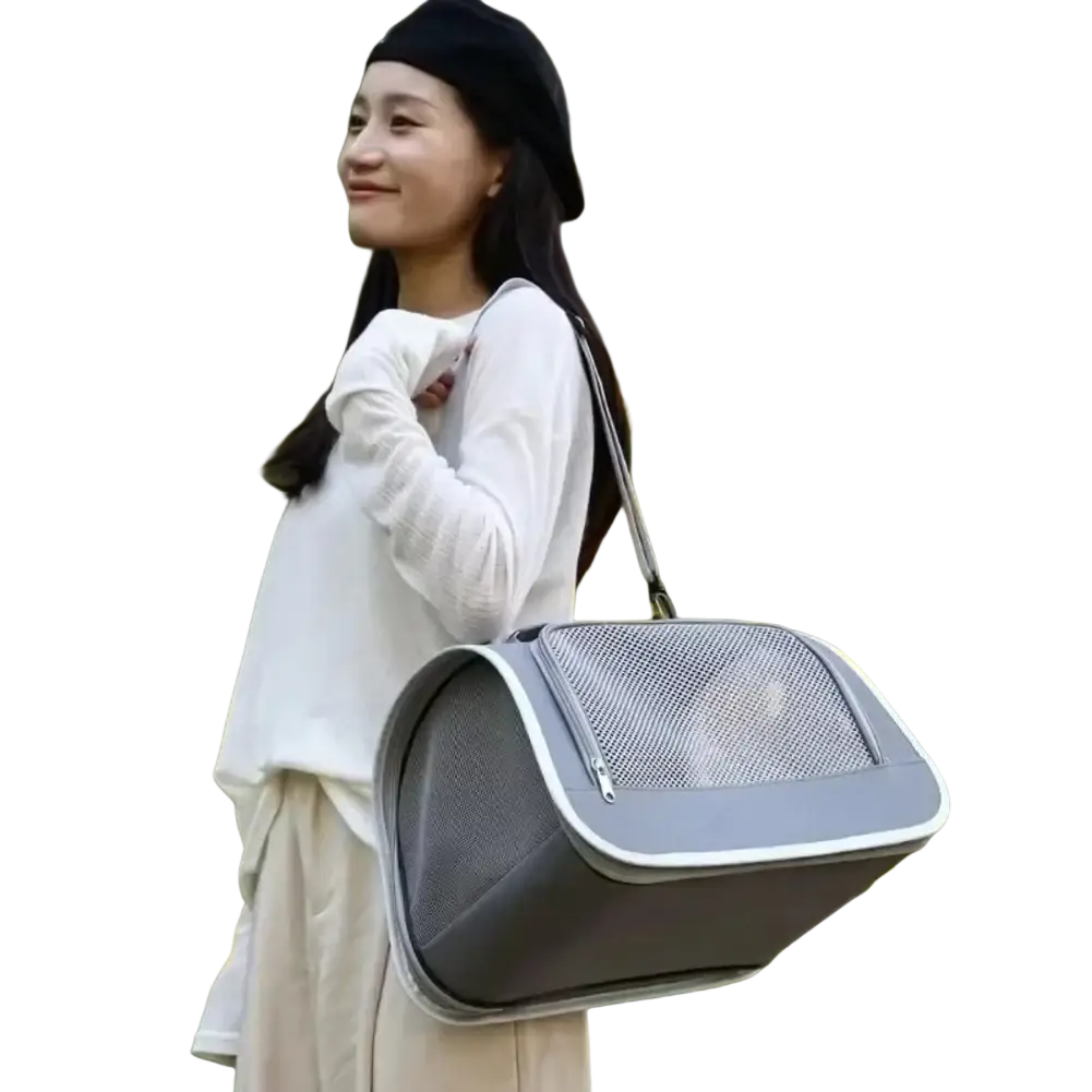 Breathable mesh pet carrier shoulder bag in gray with white trim and sturdy shoulder strap for easy transport