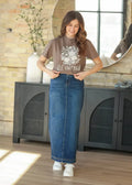 Bria dark wash denim maxi skirt in medium blue with side slit and subtle stitching on hem in a mid-rise fit