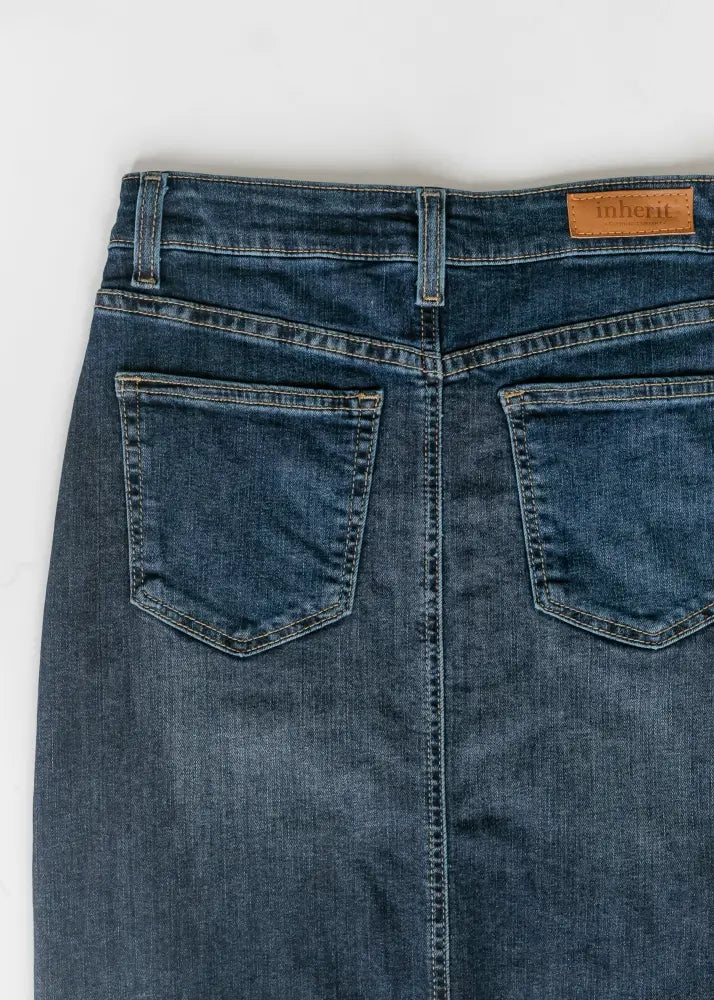 Dark blue denim maxi skirt with side slit featuring a brown leather brand patch at the waistband