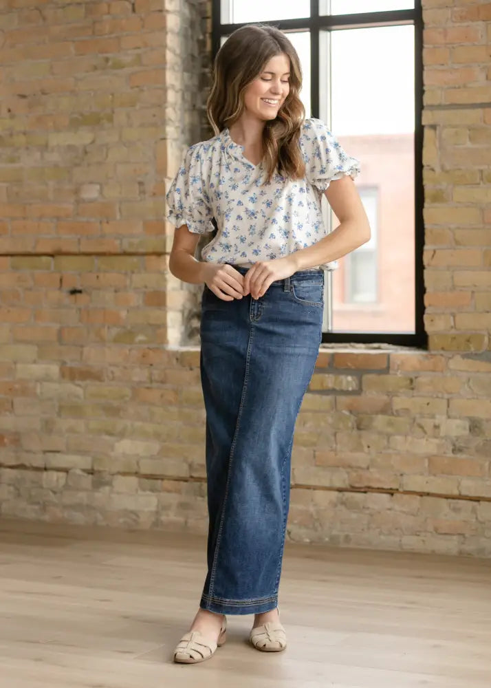 A woman wearing bria dark wash denim maxi skirt with side slit made of dark blue denim with five-pocket design