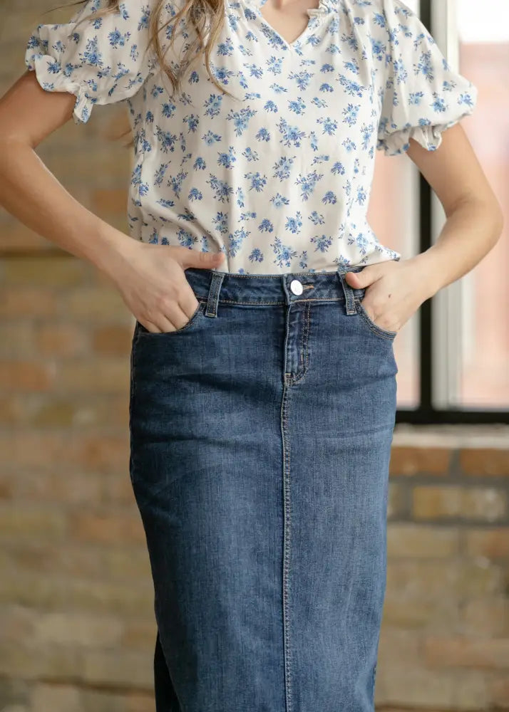 Bria dark wash denim maxi skirt with side slit in faded mid-thigh length fabric featuring classic front stitching