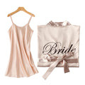 A blush pink satin bridesmaid robe with black cursive bride inscription and matching ribbon tie from embroidered satin bridal set