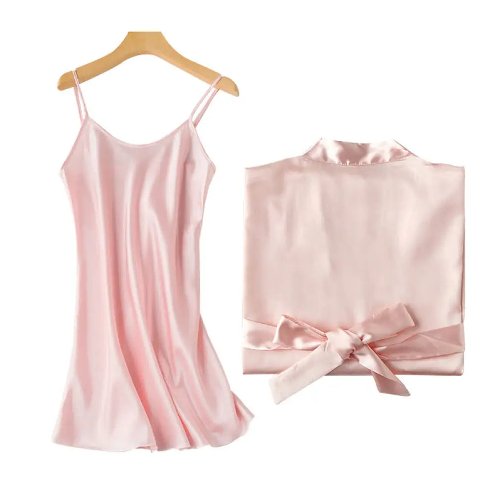 A delicate pink embroidered satin bridal nightgown and matching satin robe with thin straps and waist bow
