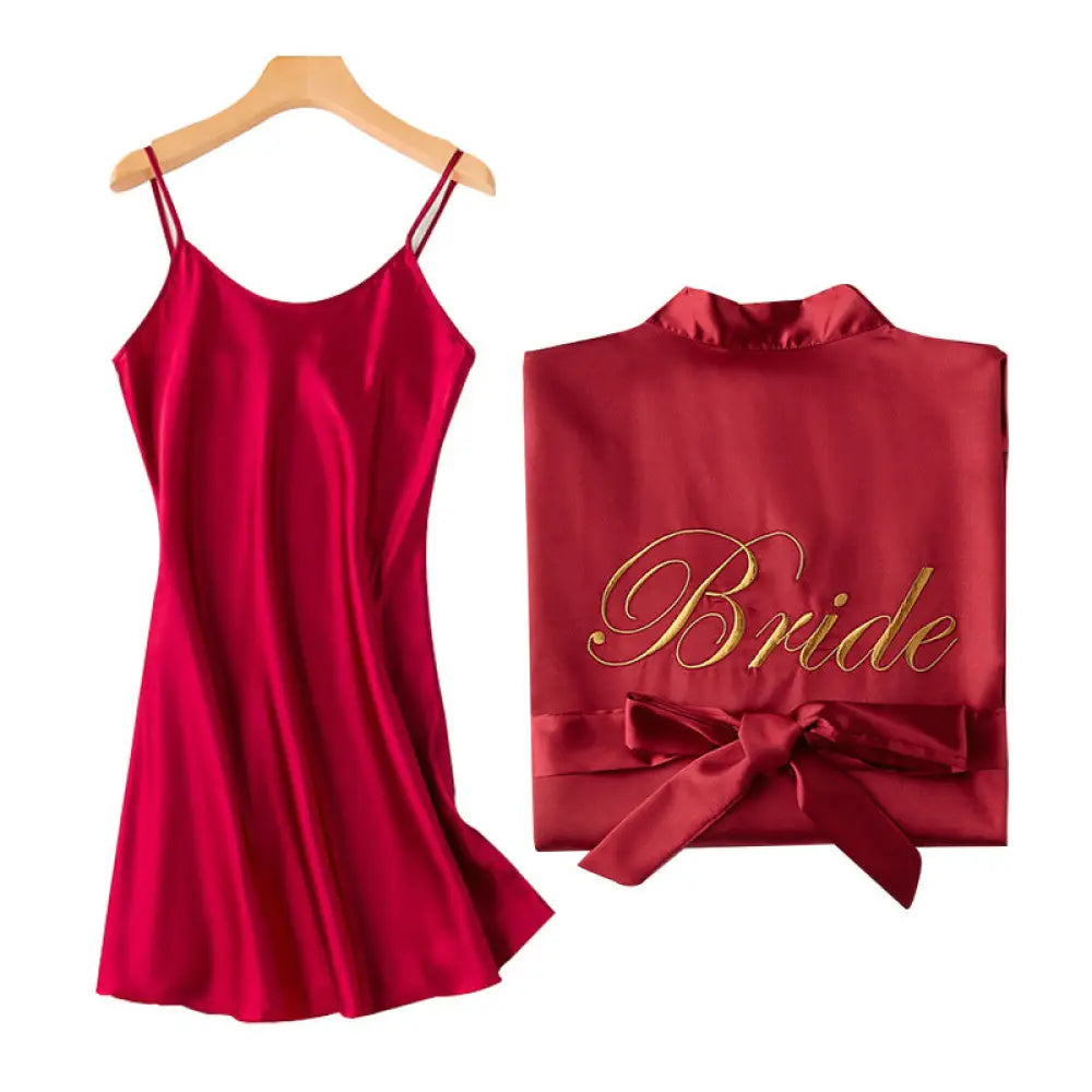 A vibrant red satin bridesmaid robe with gold cursive bride embroidery and a matching waist bow for bridal use