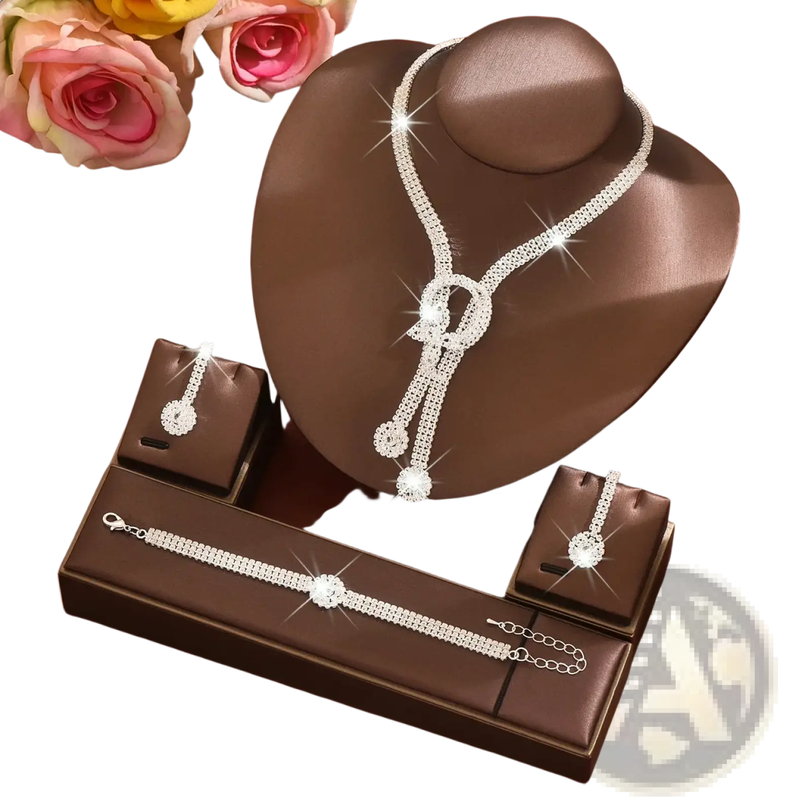 A sparkling silver bridal diamond jewelry set with cascading clear crystals and decorative knots on a brown bust
