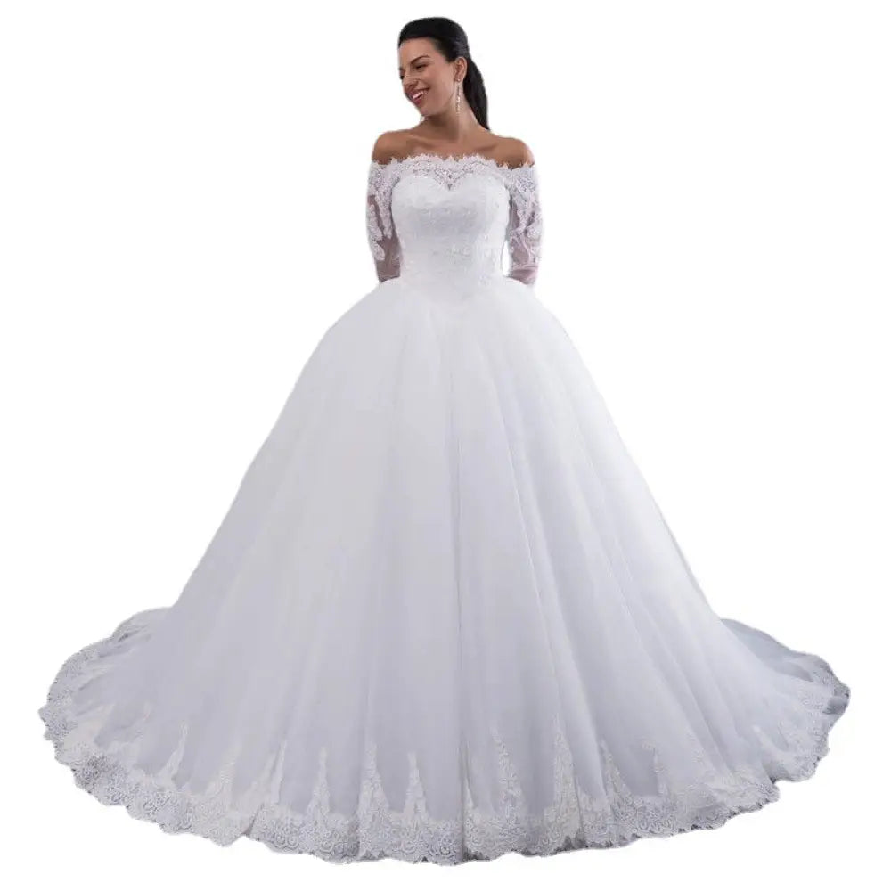 White off-the-shoulder lace wedding gown with three-quarter length sleeves and long train shown from the back