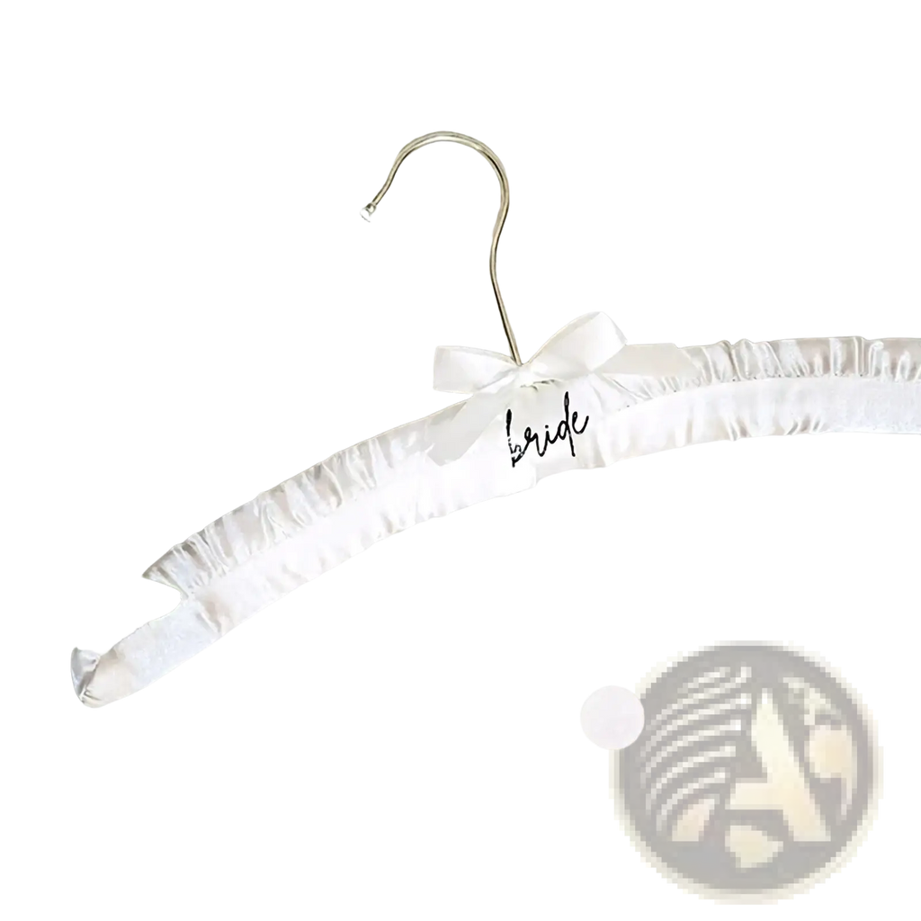 A white satin bridal hanger with a delicate bow and the word bride scripted in black for wedding dresses