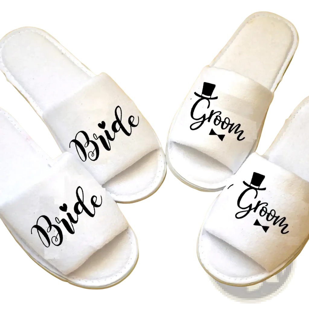 White plush bridal shower slippers with bride and groom black cursive script and top hat bow tie designs