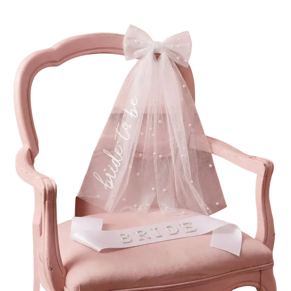Bride to be accessory set with delicate white tulle veil adorned with pearl embellishments and matching sash with bide to be script