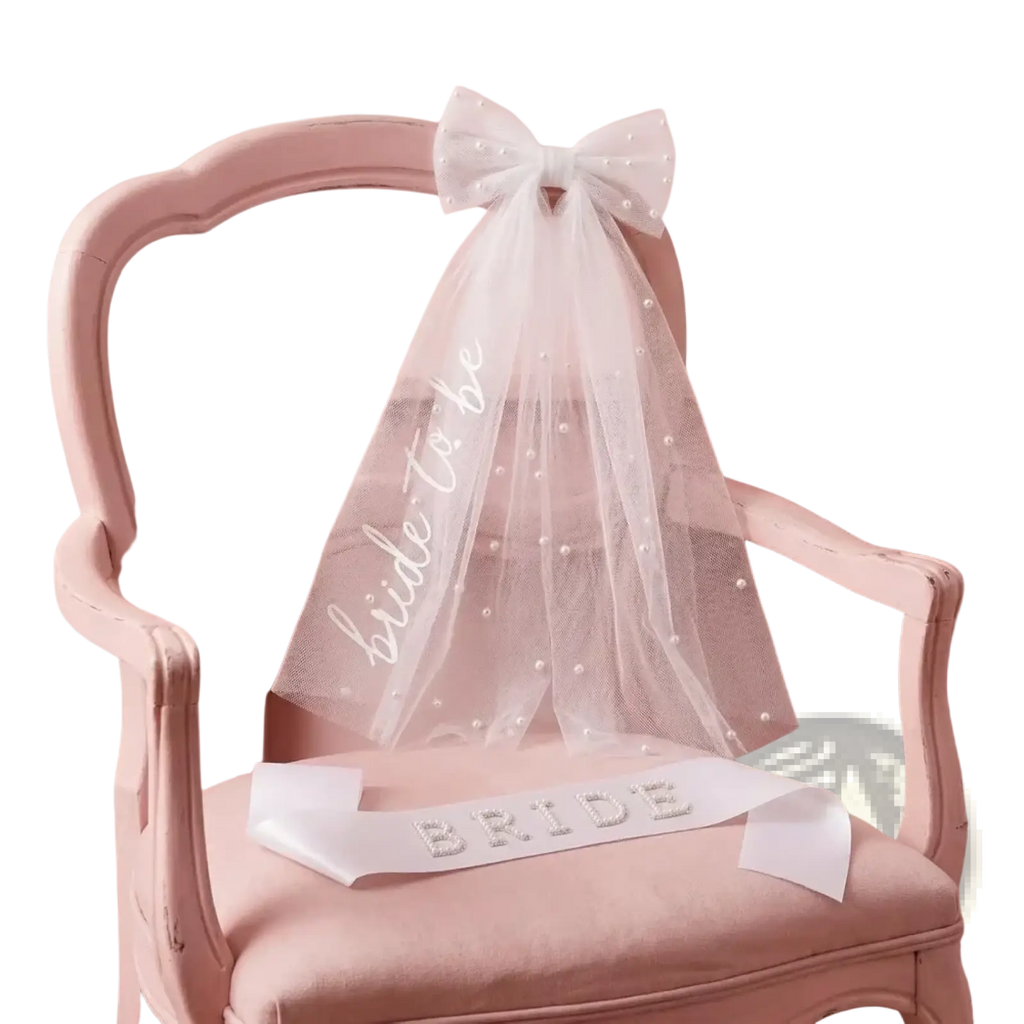 Bride to be accessory set with delicate white tulle veil adorned with pearl embellishments and matching sash with bide to be script