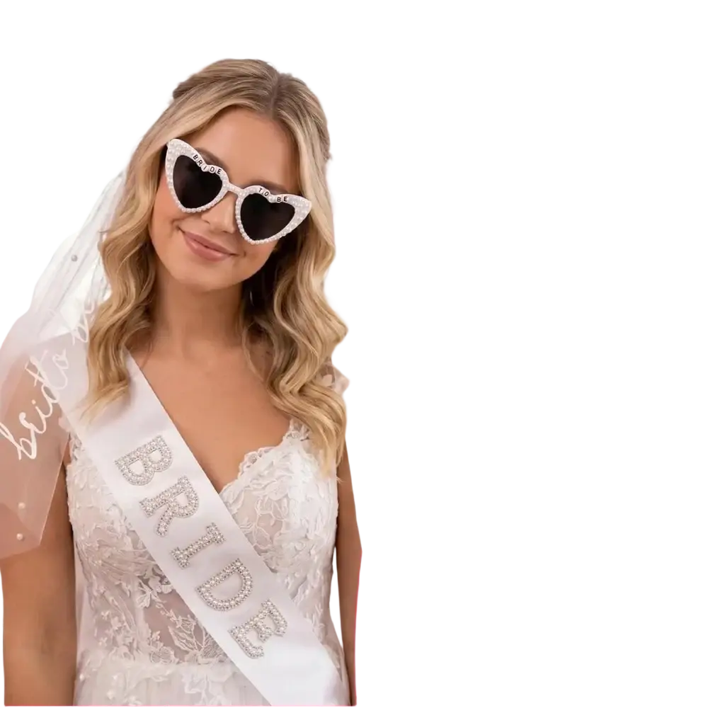 White heart-shaped bride to be sunglasses adorned with rhinestones and pearls, part of accessory set with veil and sash