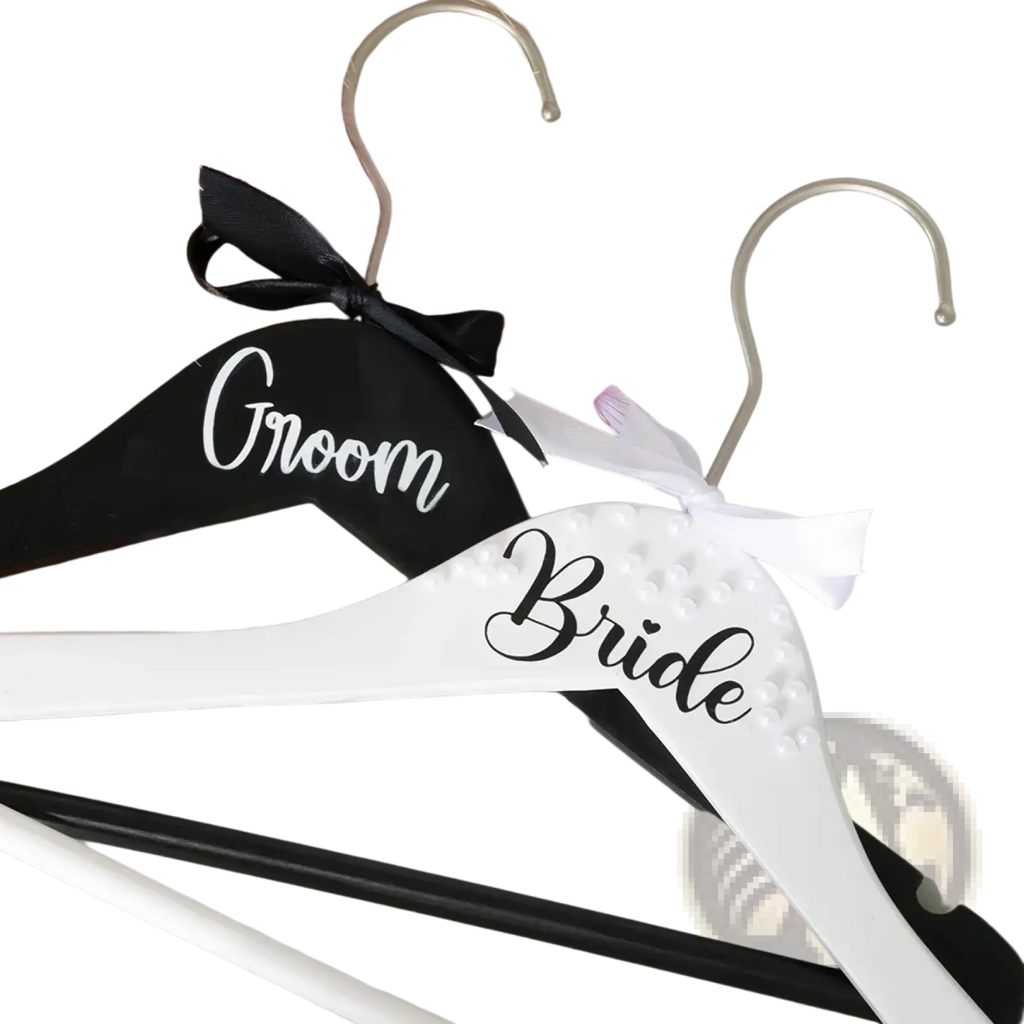 Black and white wooden bride and groom pearl wedding hangers set with black ribbon and white satin bow embellishments