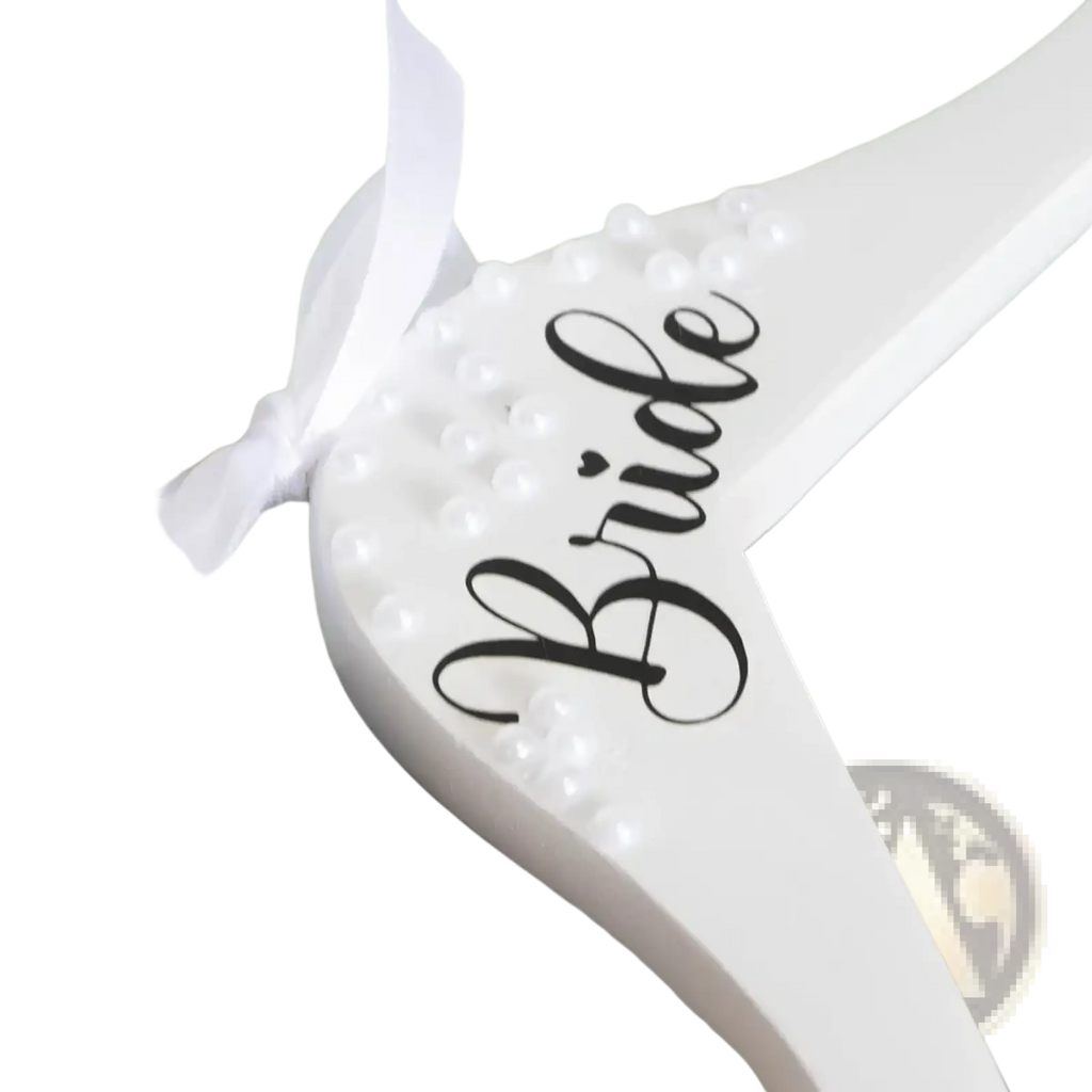White wooden bride wedding hanger with black cursive lettering, white pearls, and a white ribbon detail