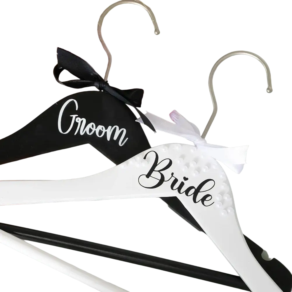Black and white wooden bride and groom pearl wedding hangers set with black ribbon and white satin bow embellishments