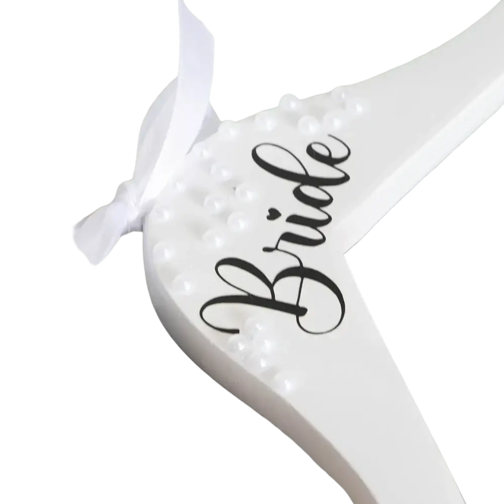 White wooden bride wedding hanger with black cursive lettering, white pearls, and a white ribbon detail