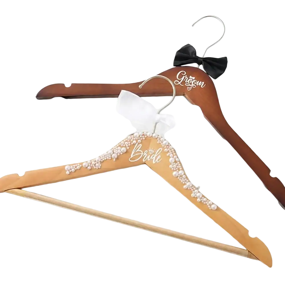 Wooden bride and groom wedding hangers set with pearl and silver script embellishments and black bow tie detail