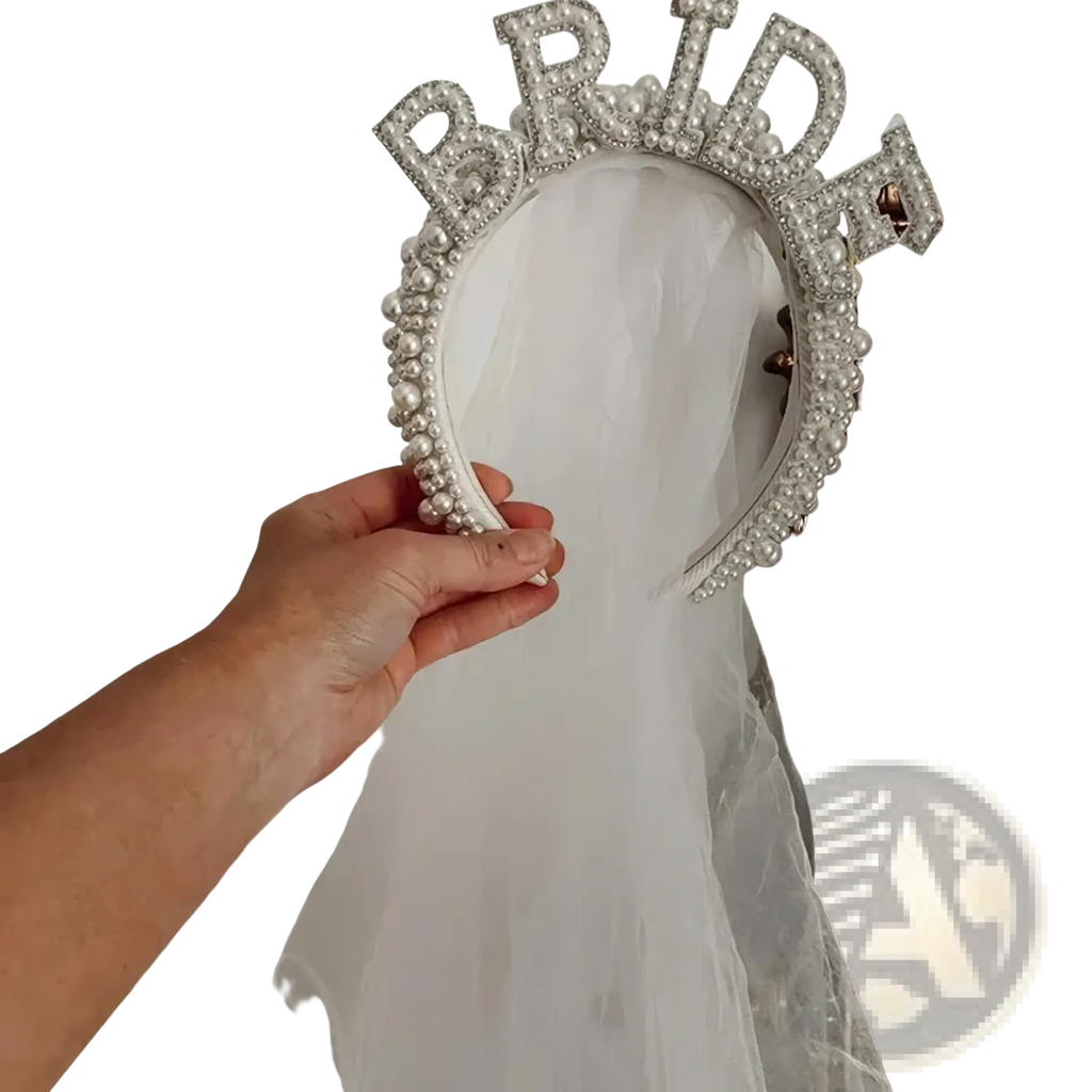 A sparkling silver bride headband pearl crown adorned with pearls and rhinestones designed for bridal wear