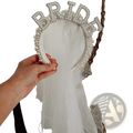 A sparkling white bride headband pearl crown adorned with rhinestones and pearls for wedding veils
