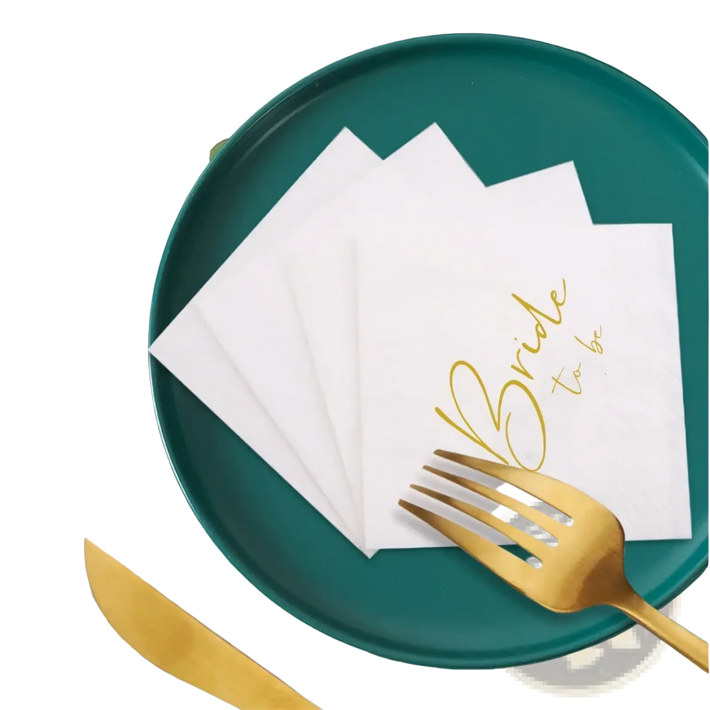 White paper bride to be napkins with gold foil script on a green plate wedding paper 50 pack