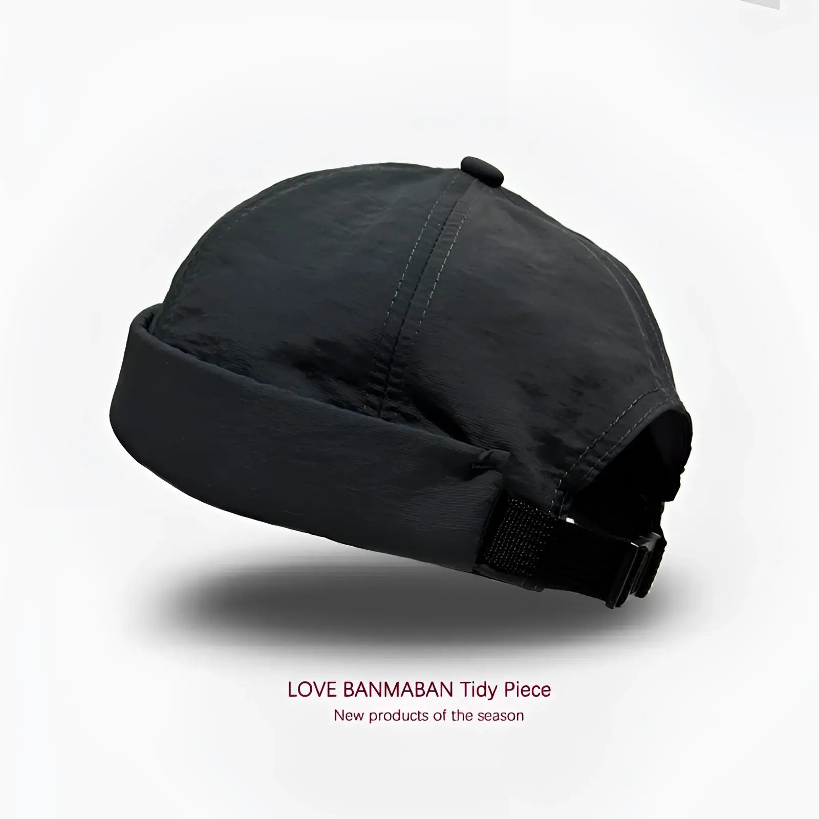 Black brimless hat quick drying adjustable cap with folded brim and strap shown from the back side