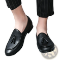 Black leather tassel loafers for young men with a polished finish and classic slip-on design
