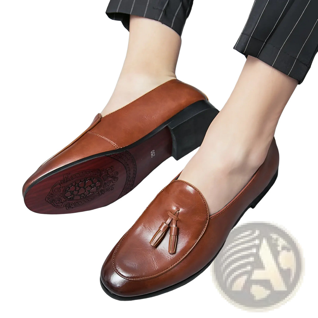 Brown leather British tassel loafers for young men with tassel detail and ornate embossed pattern on the sole
