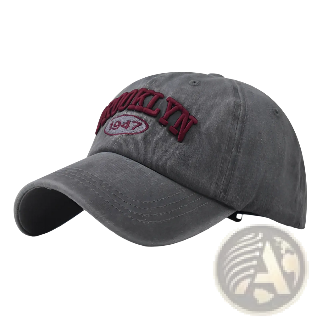 A faded gray cotton baseball hat with brooklyn 1947 embroidered in maroon thread on the front