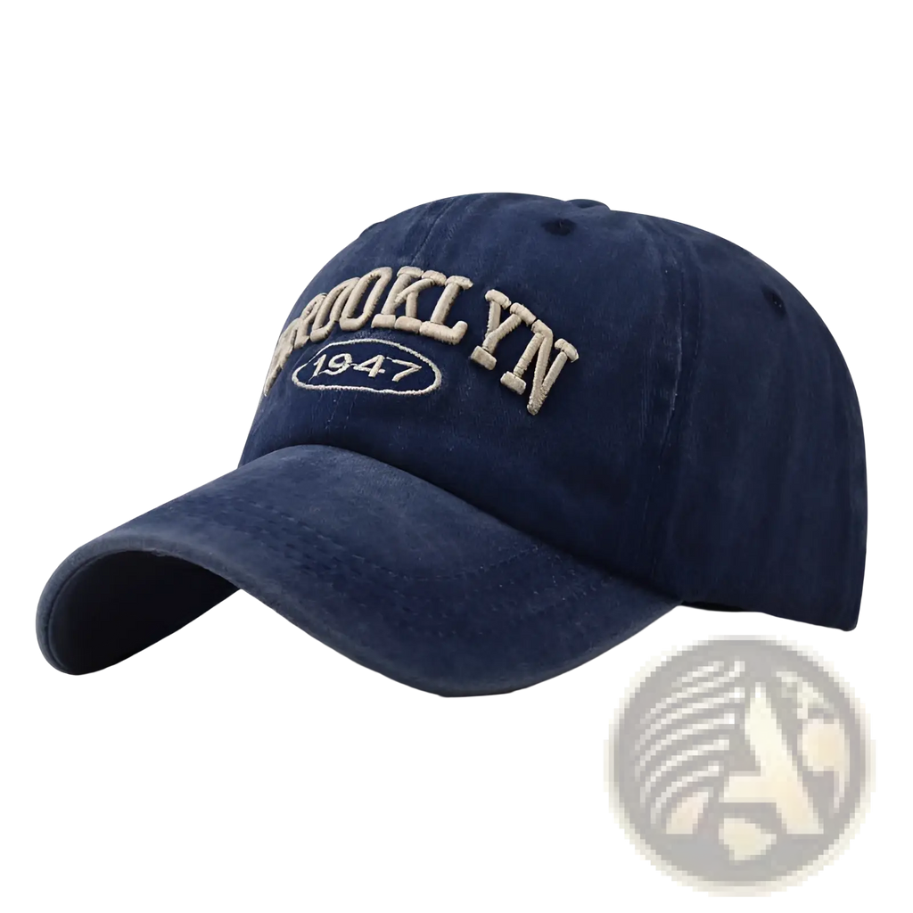 A navy blue cotton denim baseball hat with brooklyn 1947 embroidered in beige thread across the front