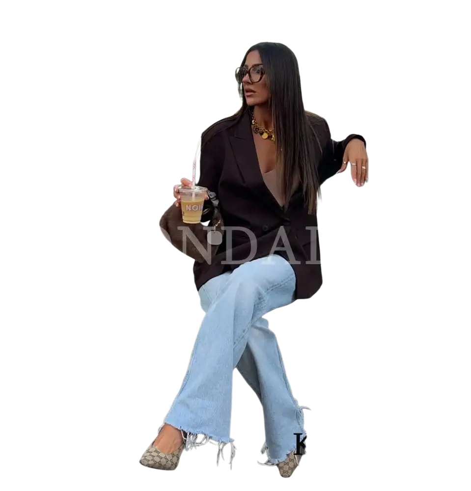 Woman wearing a brown double breasted office blazer paired with light blue frayed jeans for a professional look
