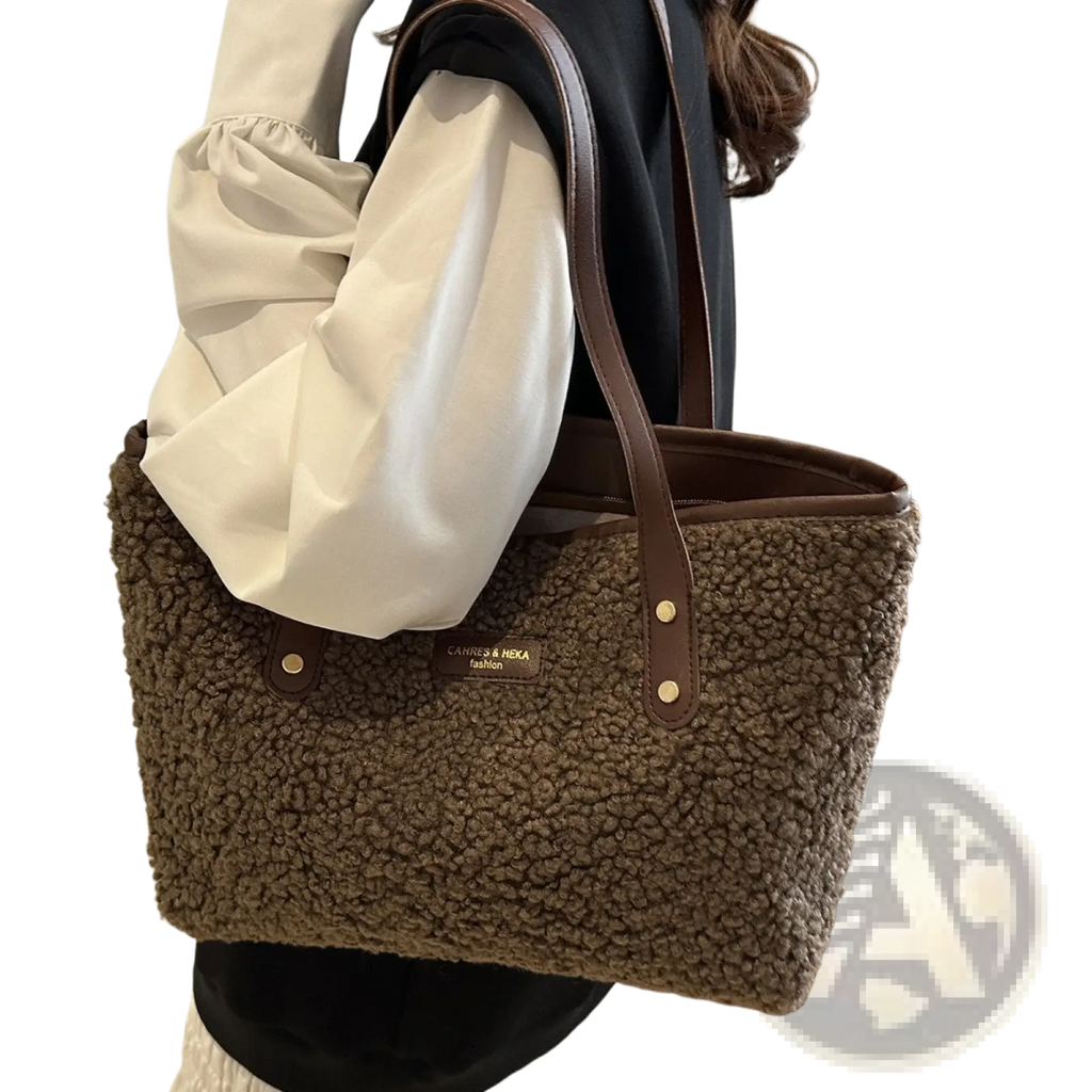 Brown faux fur tote bag with leather straps and gold tone hardware for stylish everyday use