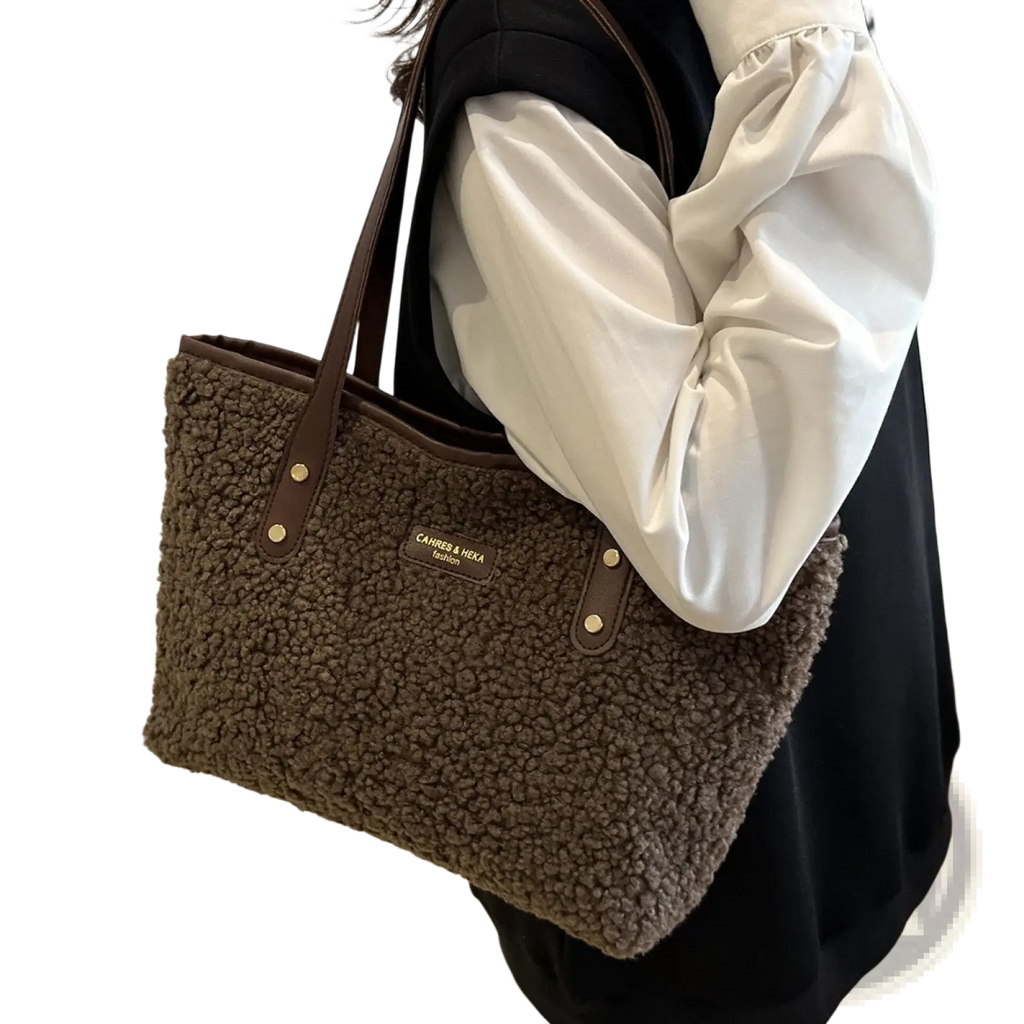 Brown faux fur tote bag with leather handles and gold tone hardware for stylish everyday use