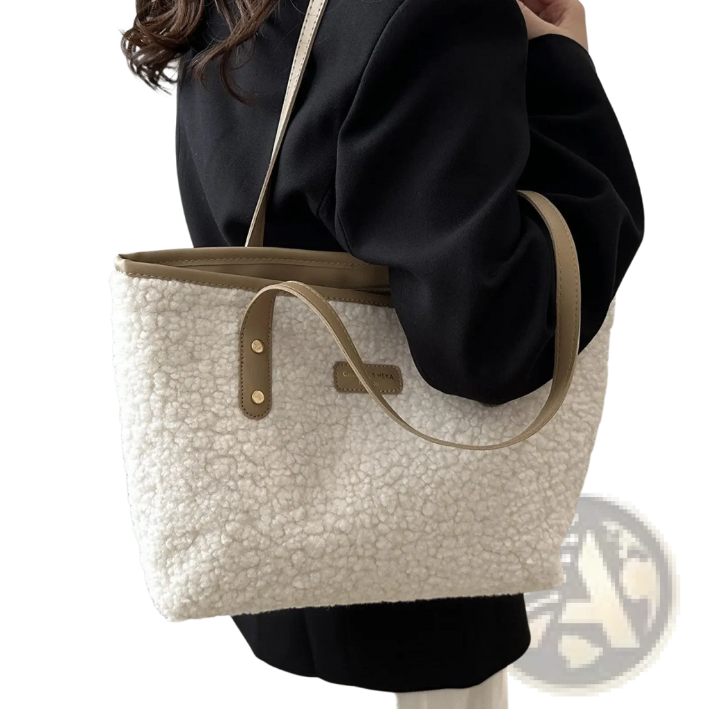 Cream-colored faux fur tote bag with tan leather handles and trim featured as brown faux fur tote bag with leather straps