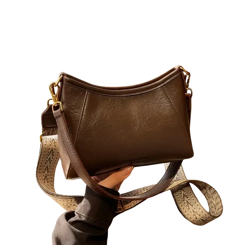 Brown leather crossbody shoulder bag for women with patterned woven strap and gold tone hardware