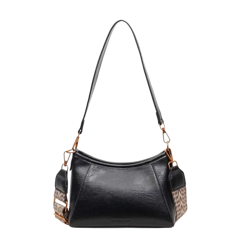 Brown leather crossbody shoulder bag for women with black textured faux leather, gold hardware, and patterned adjustable strap