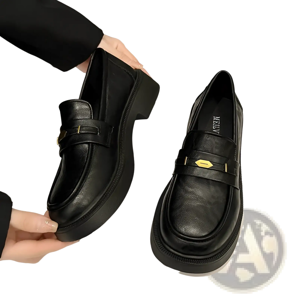 Black leather loafers with thick platform sole and gold tone metal buckle detail for stylish wear