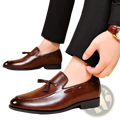 Brown leather tassel loafers with polished finish and subtle stitching details for formal dress shoes
