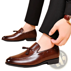 Brown leather tassel loafers with polished finish and subtle stitching details for formal dress shoes