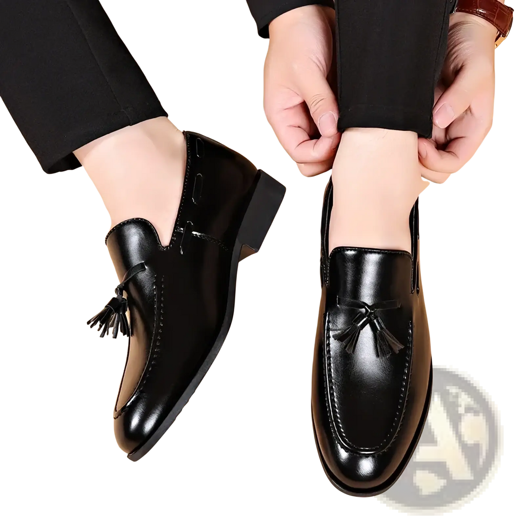 Black leather tassel loafers with a polished finish and classic design for formal dress occasions