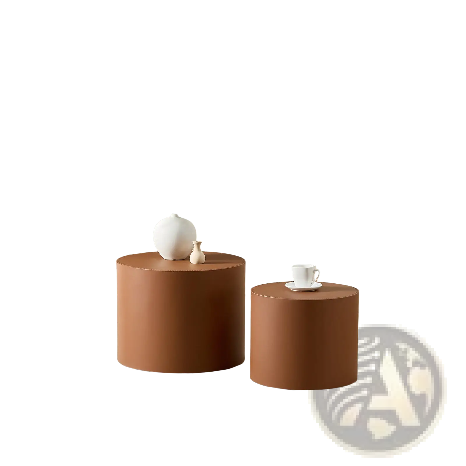 Two matte terracotta cylindrical coffee tables in brown saddle leather with one slightly larger than the other