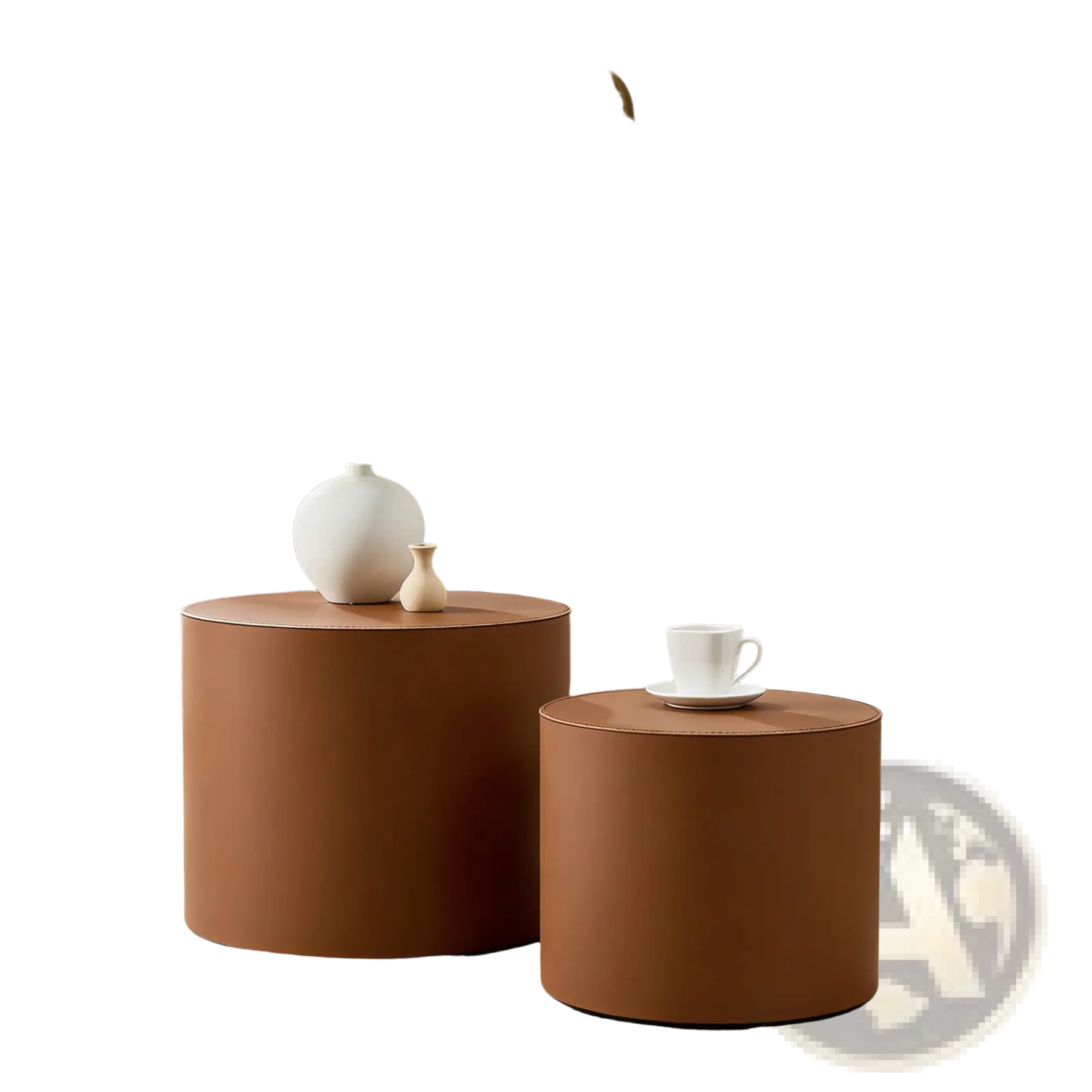 Two brown saddle leather cylindrical side tables in different sizes near a bed with gold-trimmed headboard