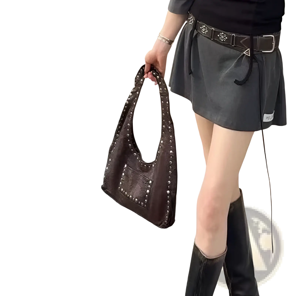 Brown studded leather shoulder bag featuring silver studs on handles and front pocket in retro hobo style