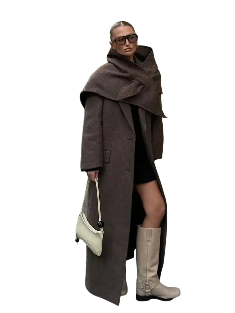 A cream-colored structured handbag with black spherical hardware accents paired with a brown wool blend winter commuter jacket