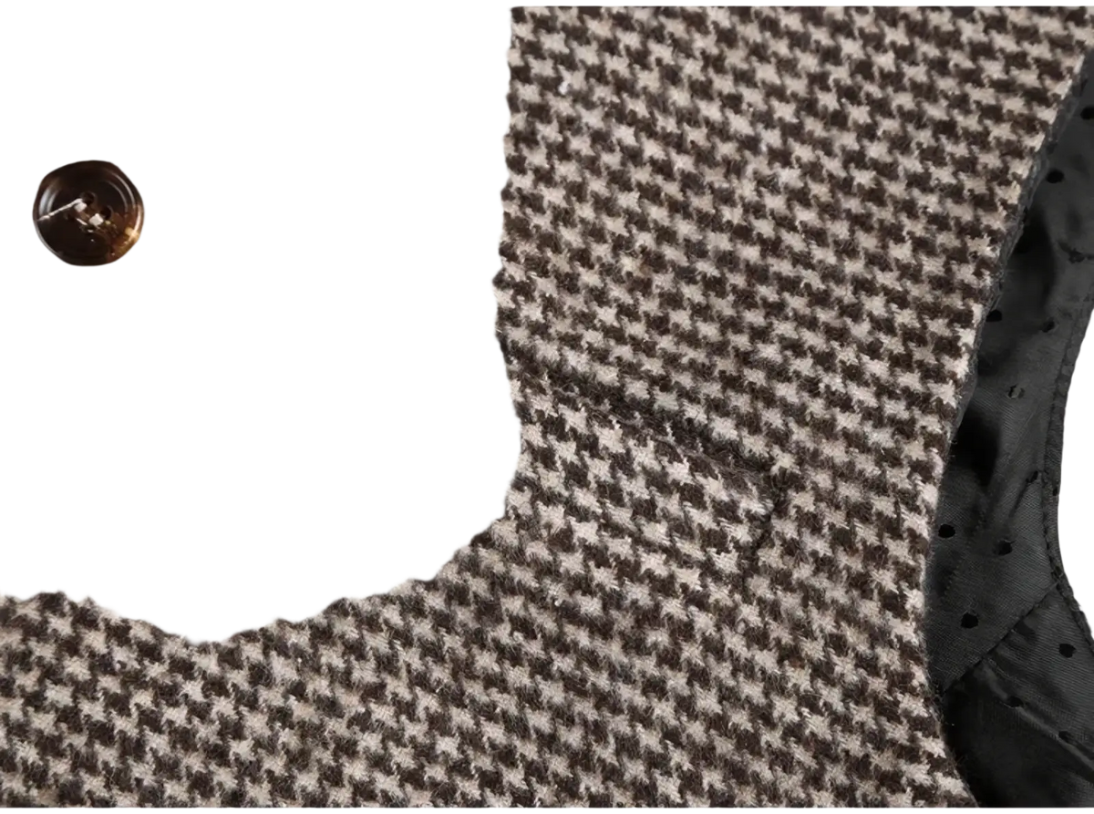 Brown wool houndstooth suit vest featuring a brown and beige houndstooth wool coat with a brown button detail