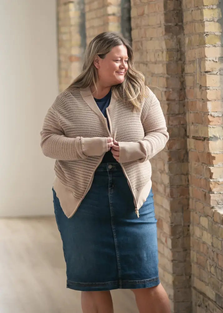 Beige textured knit cardigan with front zipper and matching cuffs paired with bryn dark wash straight denim midi skirt