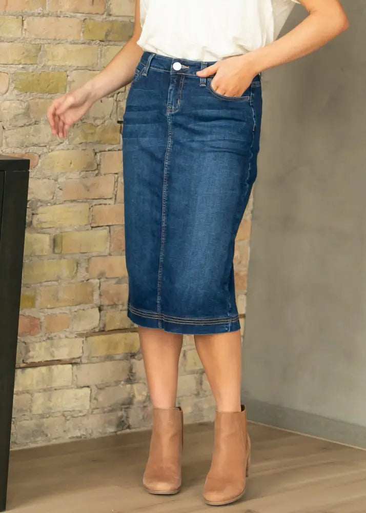 Bryn dark wash straight denim midi skirt in classic indigo with visible stitching and belt loops mid-thigh length