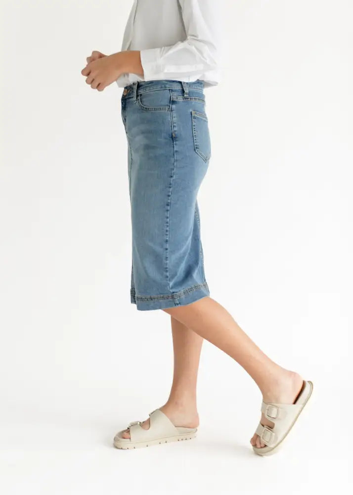 Bryn light wash sustainable denim midi skirt with classic five-pocket design and rolled hem in light-wash denim