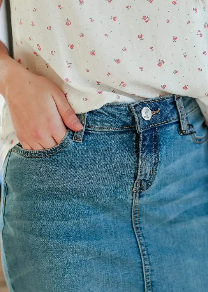 Bryn light wash sustainable denim midi skirt in blue with button closure and subtle fading details
